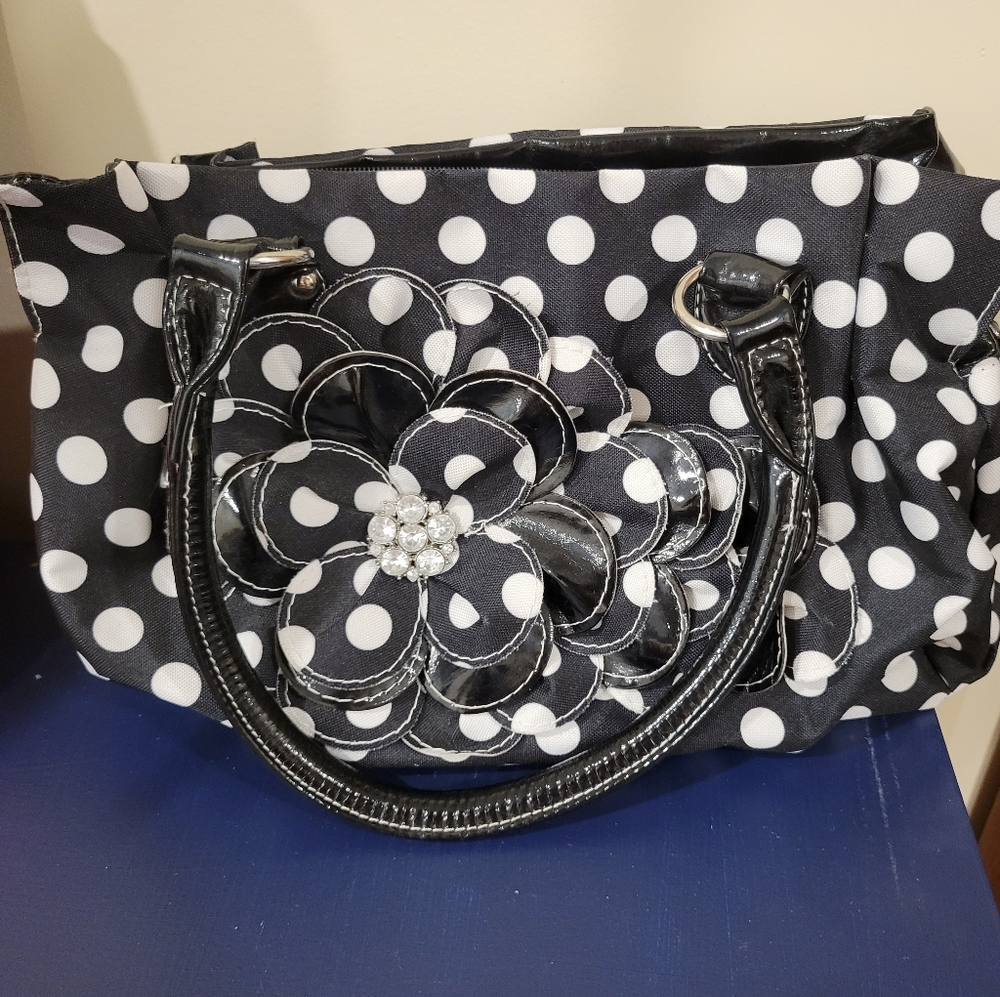 Black and white purse with three large compartments flower and gems